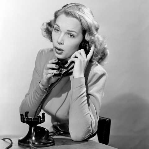 Hello? Black & White photo of a woman answering a landline circa 1950's - Handy Entertainment
